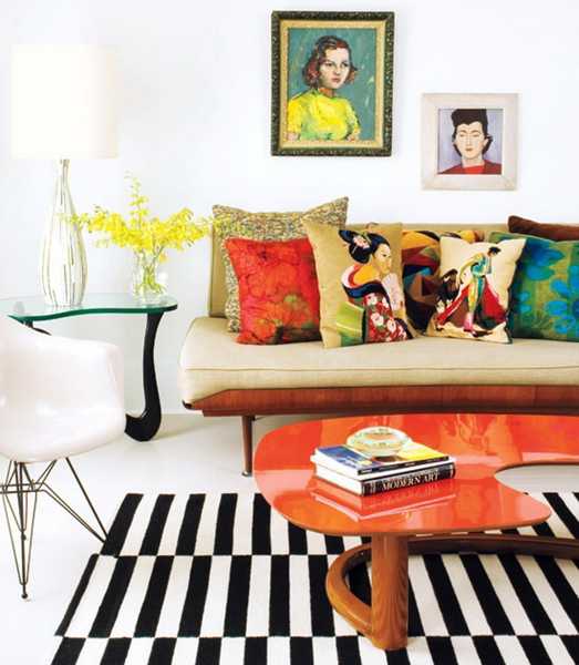 orange coffee table and colorful cushions