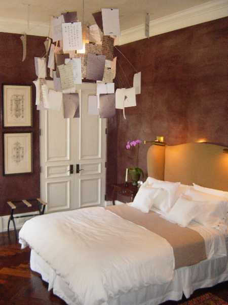 antique prints on wall and chandelier