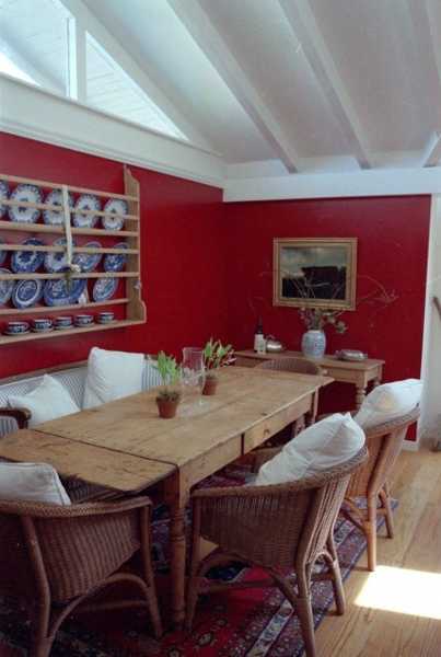 Dining room with red walls and hardwood table