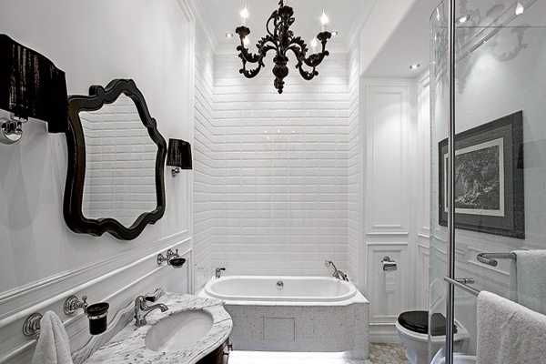 white bathroom design with black chandelier and mirror frame in modern style