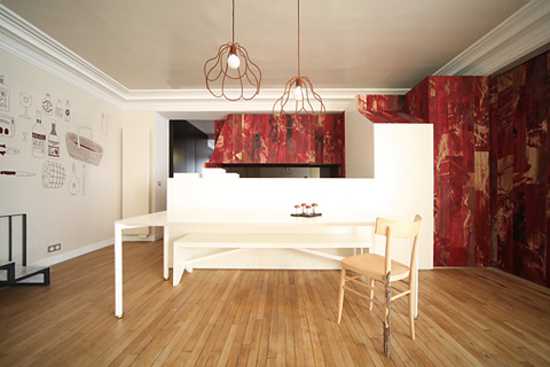 Modern kitchen design with white cabinets and red wall panels