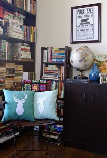 White Deer applique on a blue cushion
