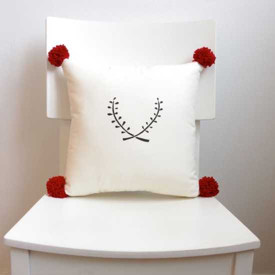 red pompoms on a white cushion