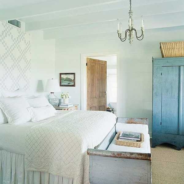 white linens and blue bedroom furniture in the country house style