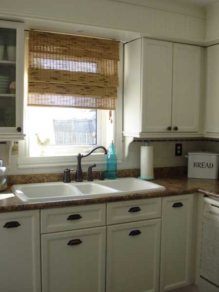white kitchen cabients and faucets in vintage style