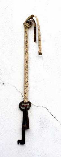 Wall decoration in vintage style, old key and tape measure