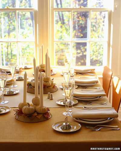 covered table decorate with mini pumpkin candle centerpieces and napkins in neutral color