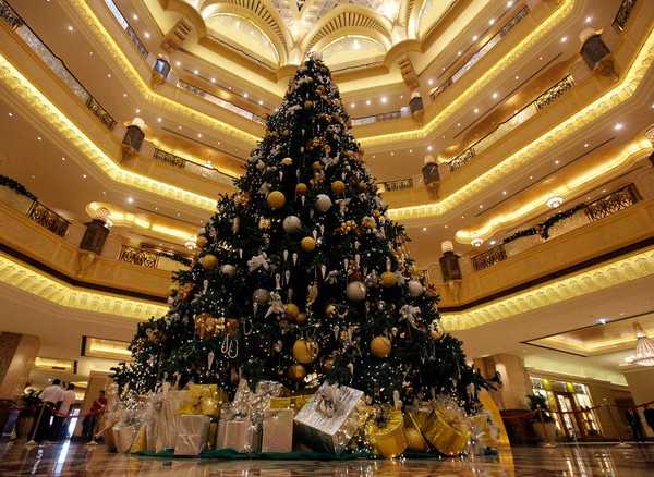 black Christmas tree with decorations in golden colors