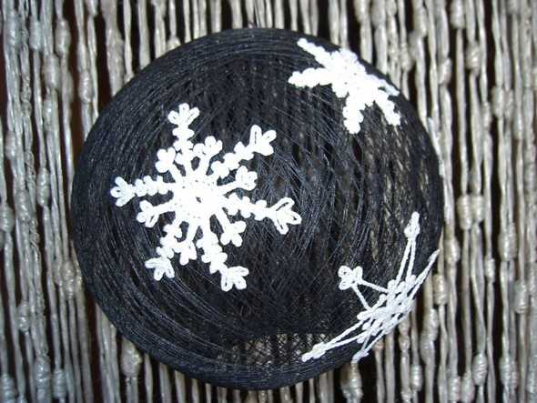 black Christmas ball with white snowflakes