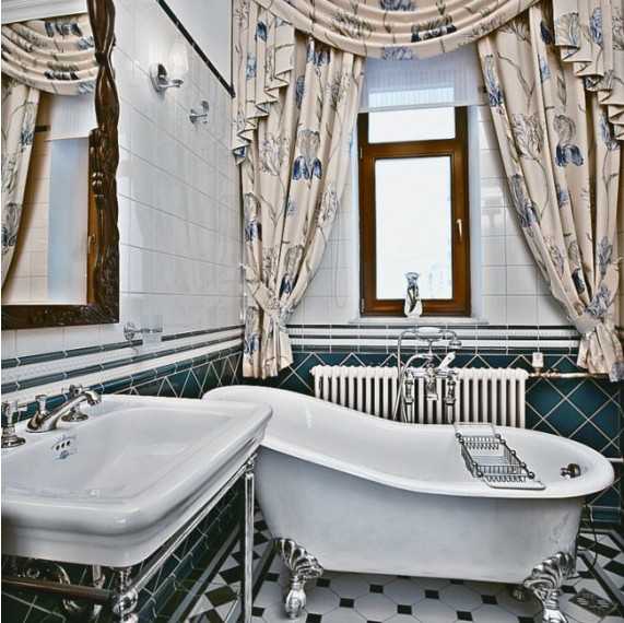 bathroom design with claw foot tub and carved wood mirror frame
