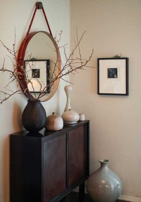  round wall mirror and decorative vases 