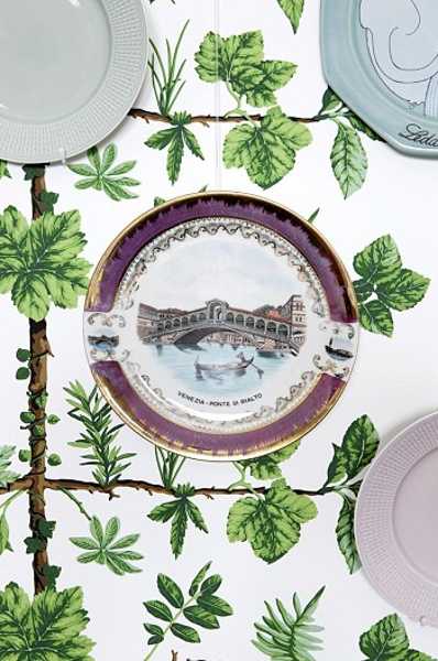 decorative plates on the wall with green wallpaper