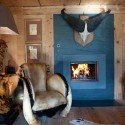 blue fireplace and unique lamp and a chair decorated with fur