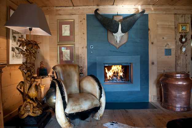 blue fireplace and unique lamp and a chair decorated with fur