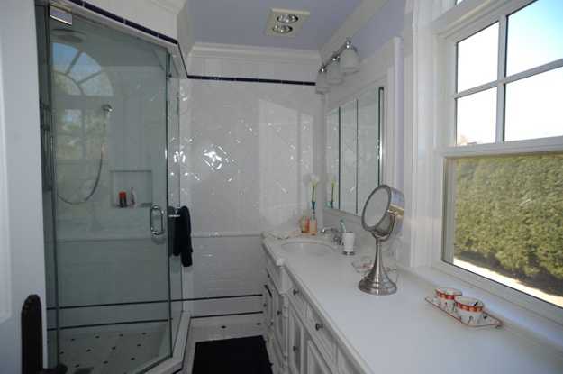 modern bathroom with a glass door and large window show
