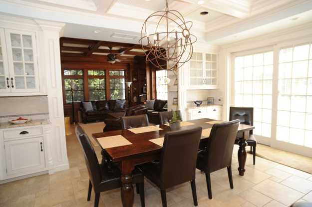 dining room with large wooden table and metal candlestick