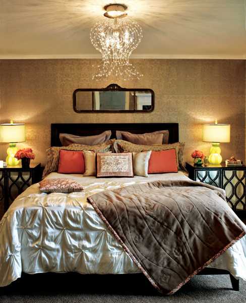 structured bedding set in neutral colors and orange pillows