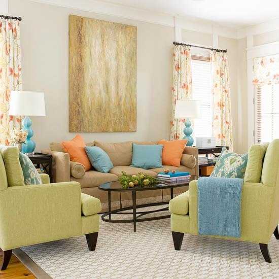 green living room furniture with blue and orange decorative pillows
