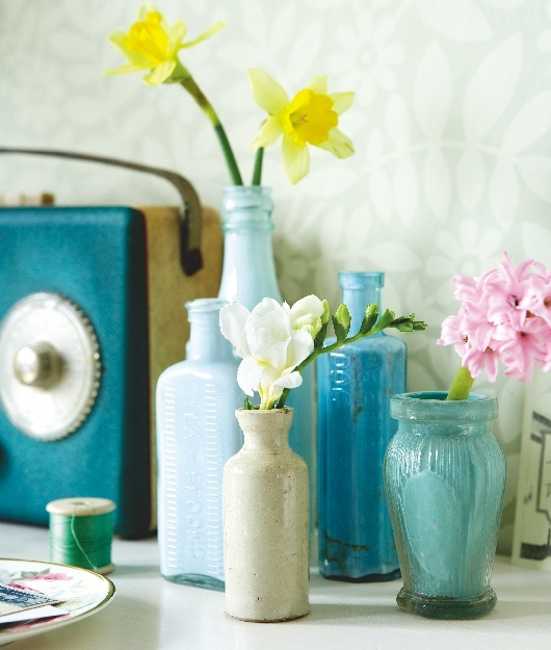 vintage glass jars and bottles with spring flowers