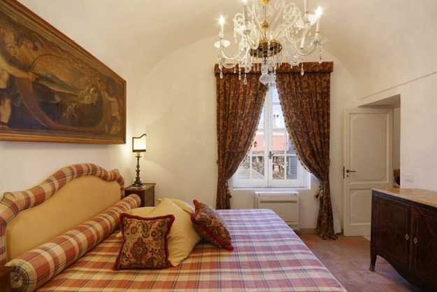bedroom decoration with antique painting and natural fabrics in the Italian style