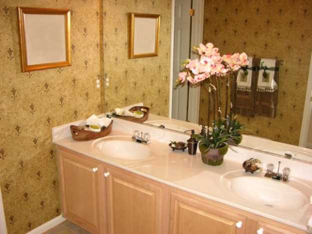 Pink flowers on bathroom vanity with two sinks
