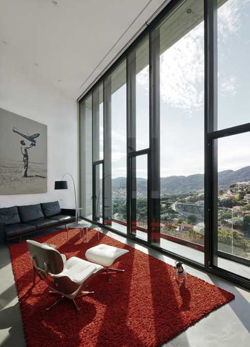 red carpet in black and white living room with large windows