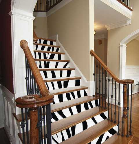 wooden staircase with black and white stripes