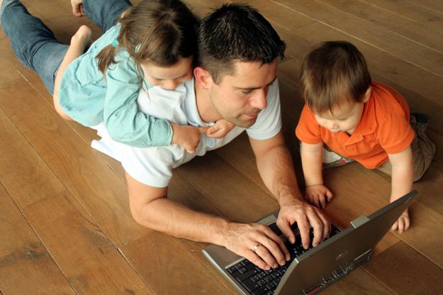 Father and children looking at laptop