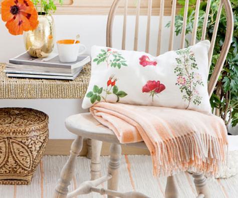 white cushion with red flower designs